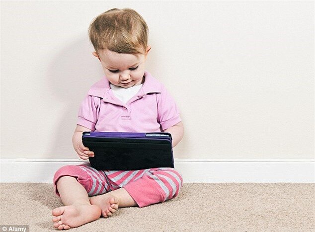 Babies should be given iPads as soon as they are born to help them learn, according to scientists (file picture)