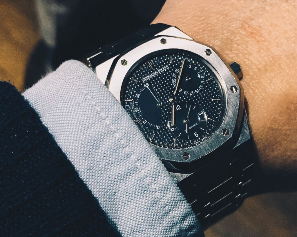 closeup of steel audemars piguet watch on wrist under shirt cuff