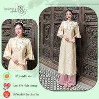 Áo dài cách tân cổ tròn màu kem gấm tơ dáng suông tay loe đính cúc bọc tôn da - Áo dài Tường Vy