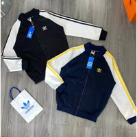 Áo khoác bomber nam nữ Das nỉ da cá thêu logo cỏ ba lá ngực phối tay thêu 3 sọc vàng hàng mới hottrend 2024