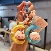 Móc khóa heo hồng bay giữa vầng trăng khuyết