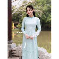 Pass áo dài Ánh Xuân hoạ tiết hoa mai màu xanh ngọc.