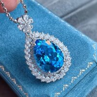 Water droplet shaped necklace with blue, sparkling topaz inlaid